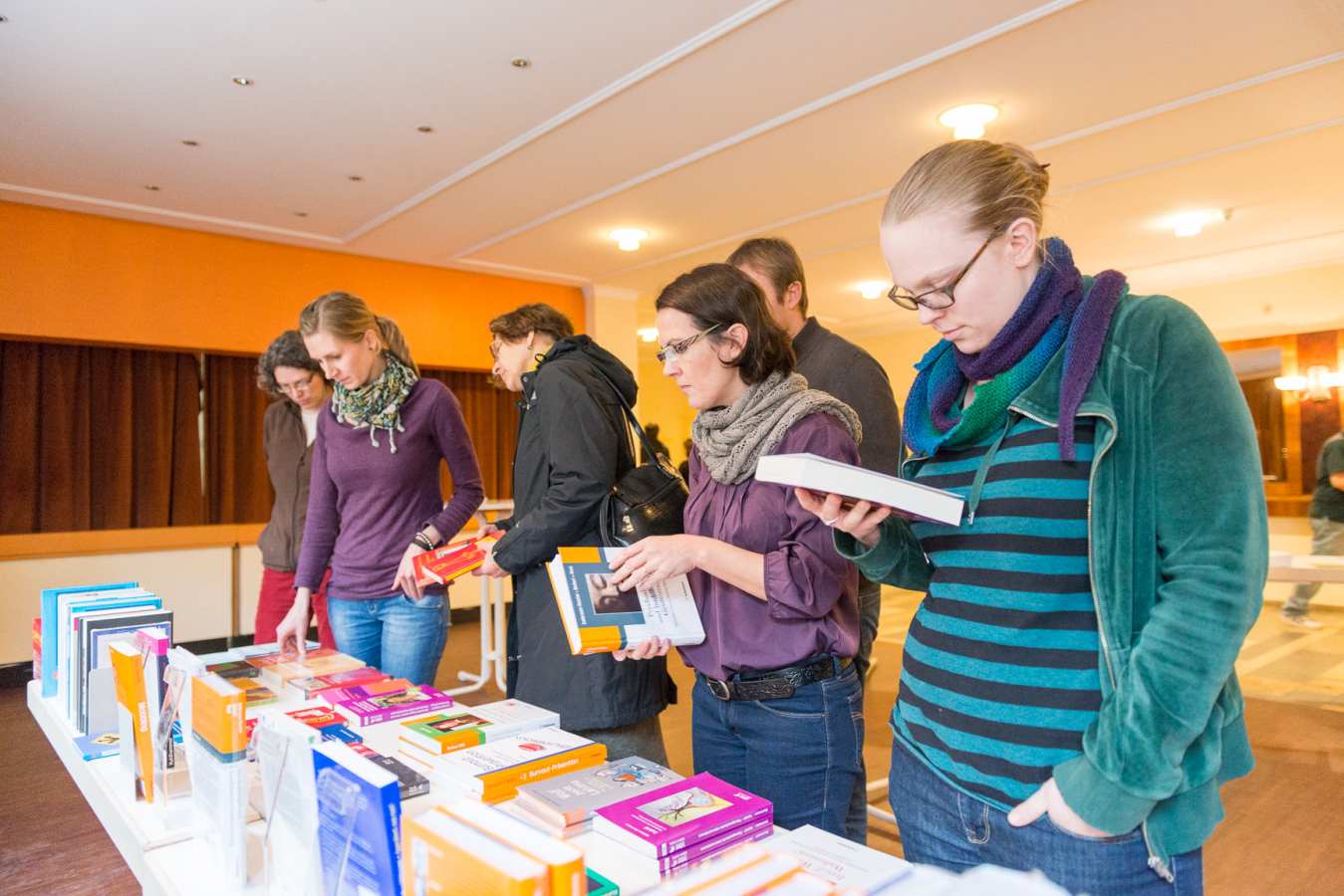 Teilnehmer informieren sich bei einem Info-Stand der Buchhandlung Lehmann